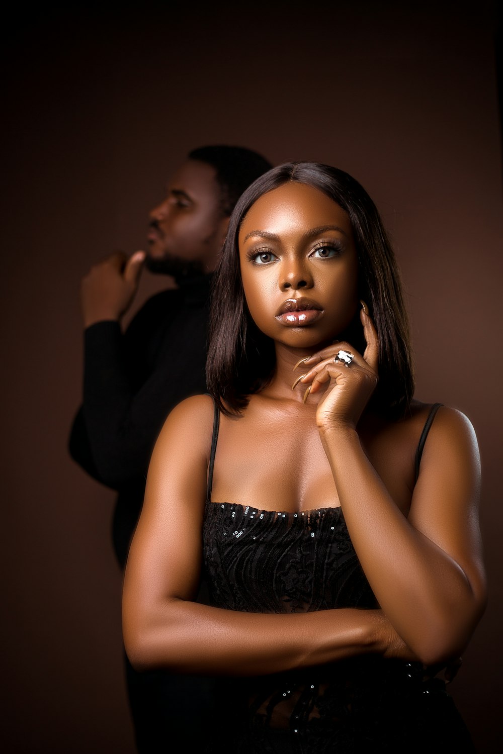 a woman in a black dress and a man in a black shirt