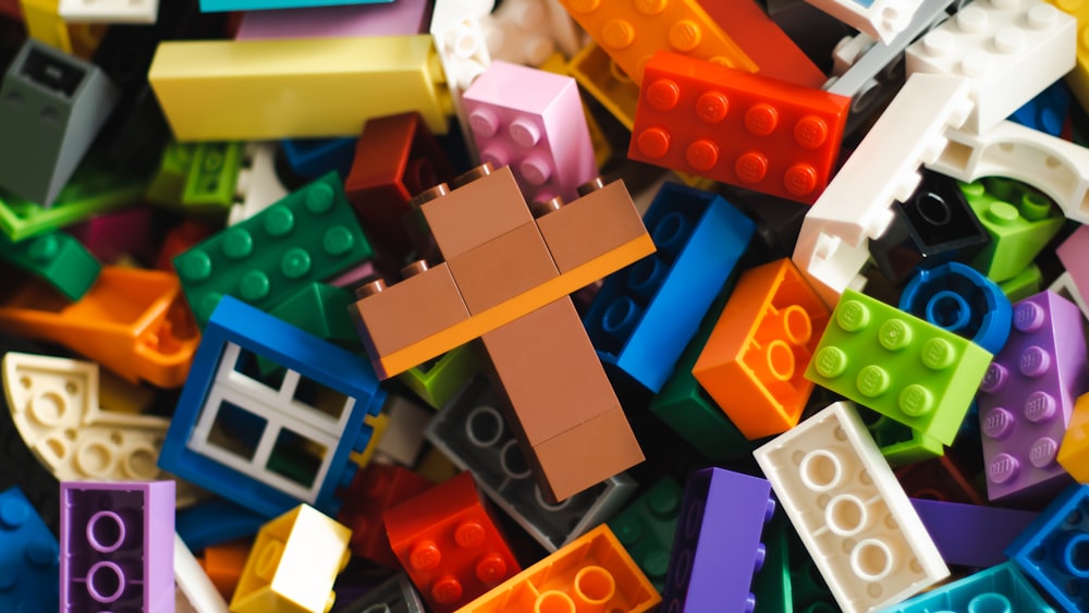 a pile of colorful legos with a man on it