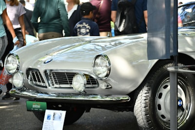 A classic vintage car showcased at an outdoor exhibition.