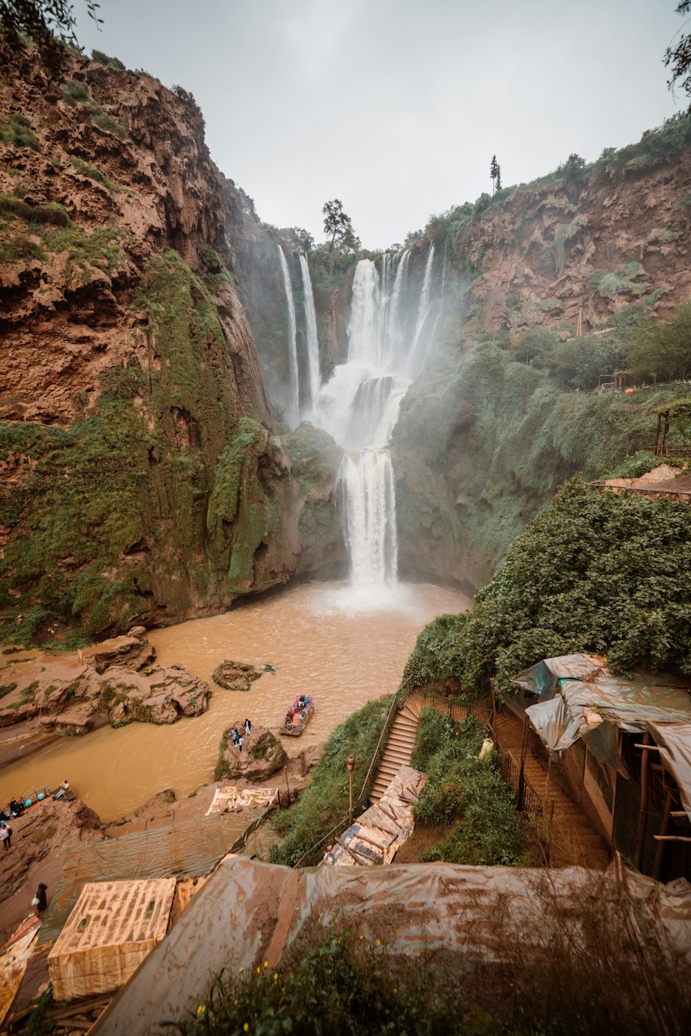 a group of people standing in front of a waterfall