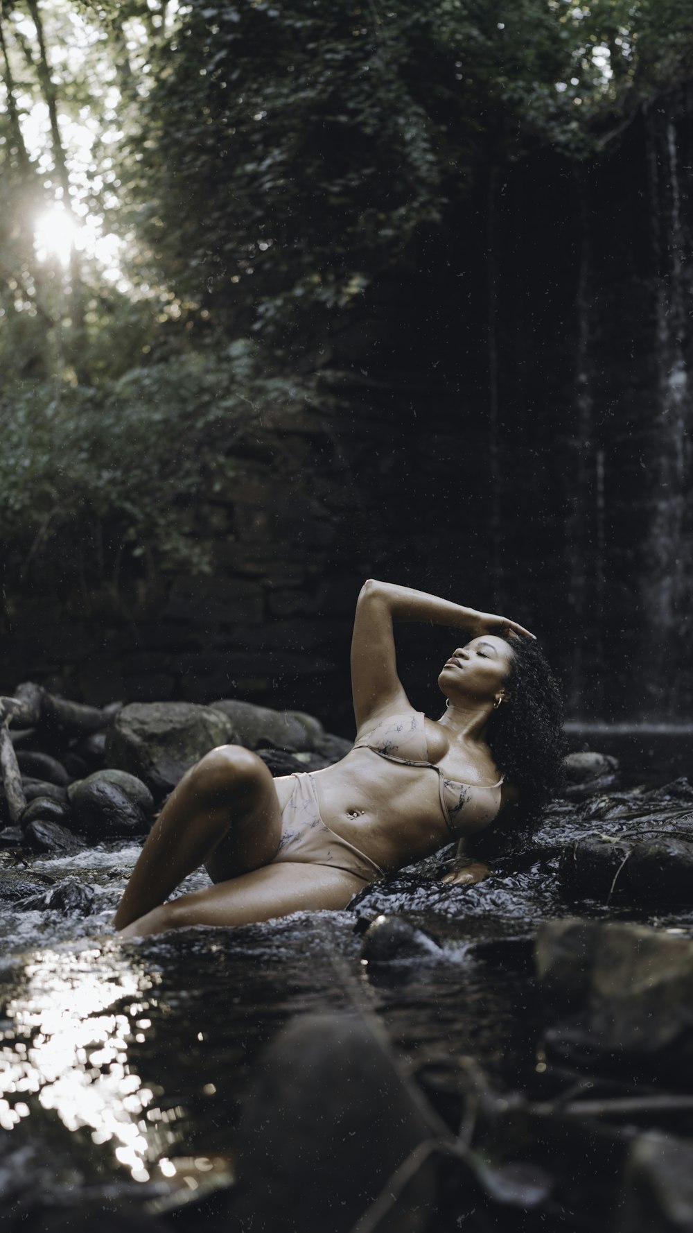 a woman in a bikini laying in the water