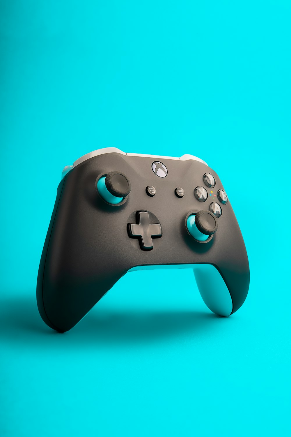 a close up of a controller on a blue background