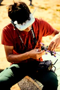 A racer pilot adjusting goggles while preparing for a drone race.