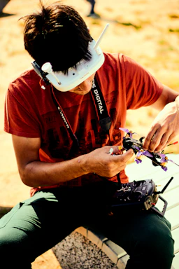 A friendly customer support agent wearing a headset ready to assist with drone rental inquiries.