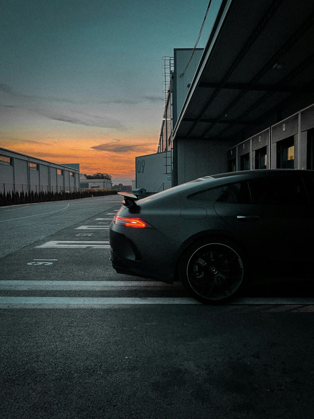 a car parked in a parking lot at sunset