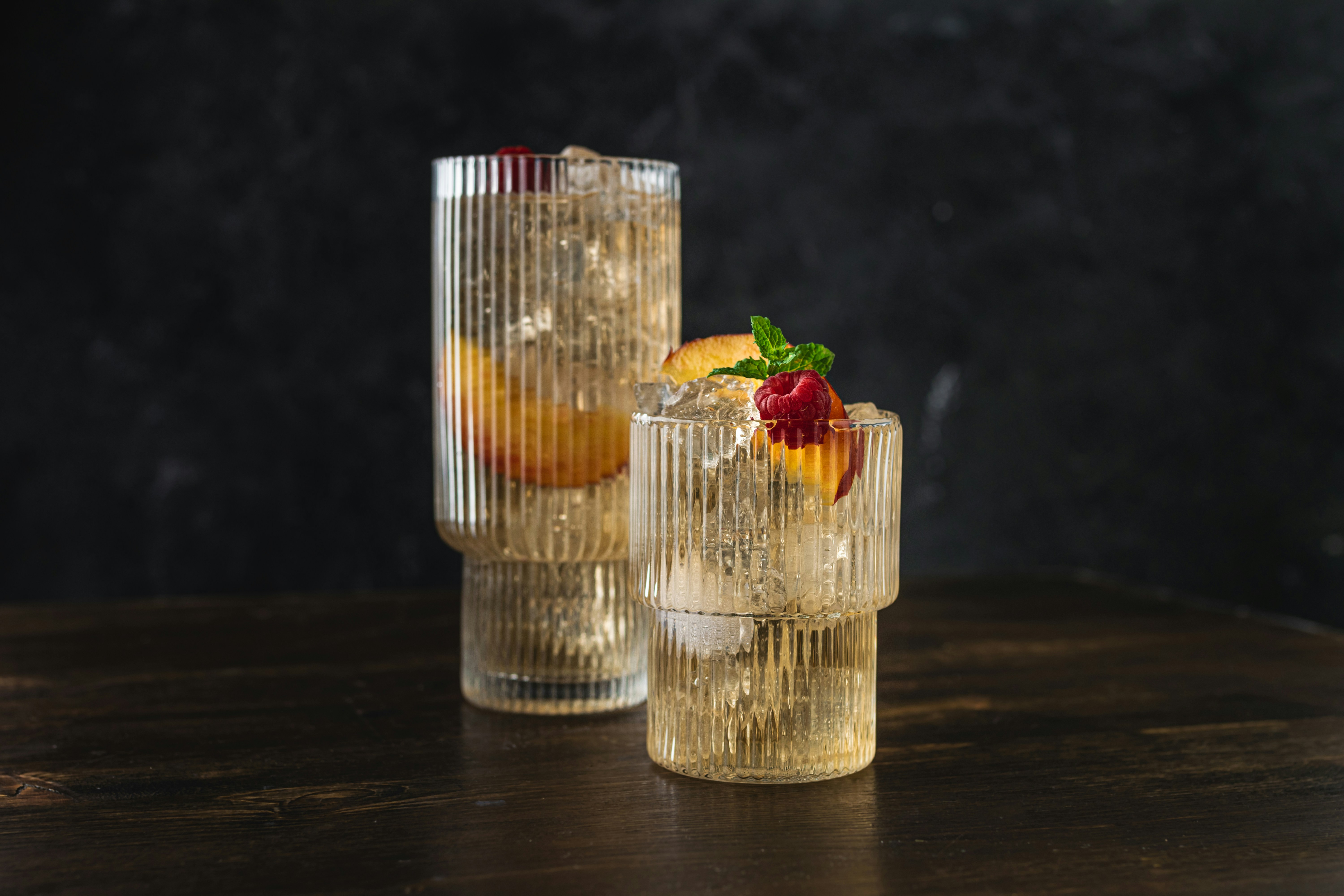 a couple of glasses filled with drinks on top of a table