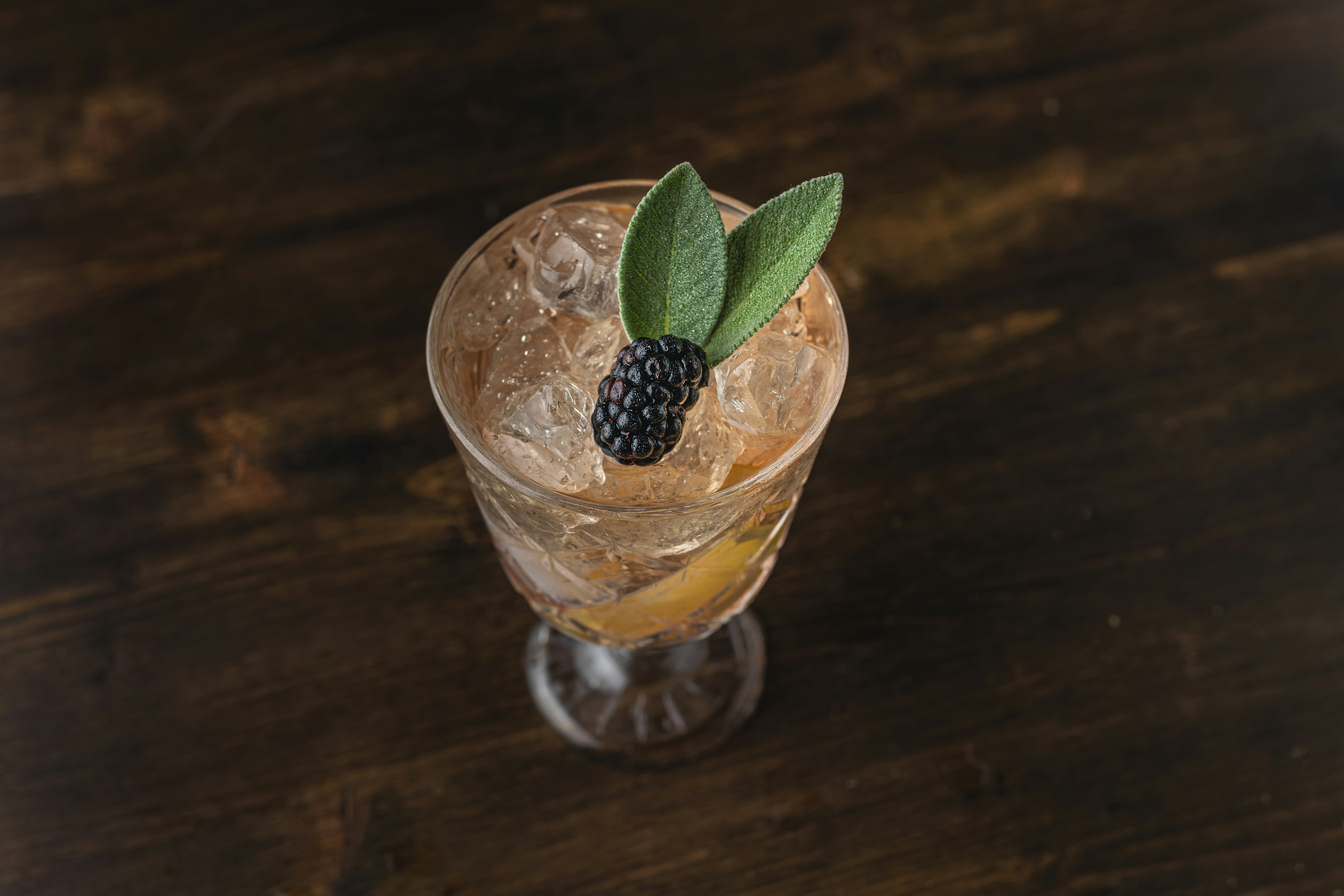 a vase filled with flowers sitting on top of a wooden table