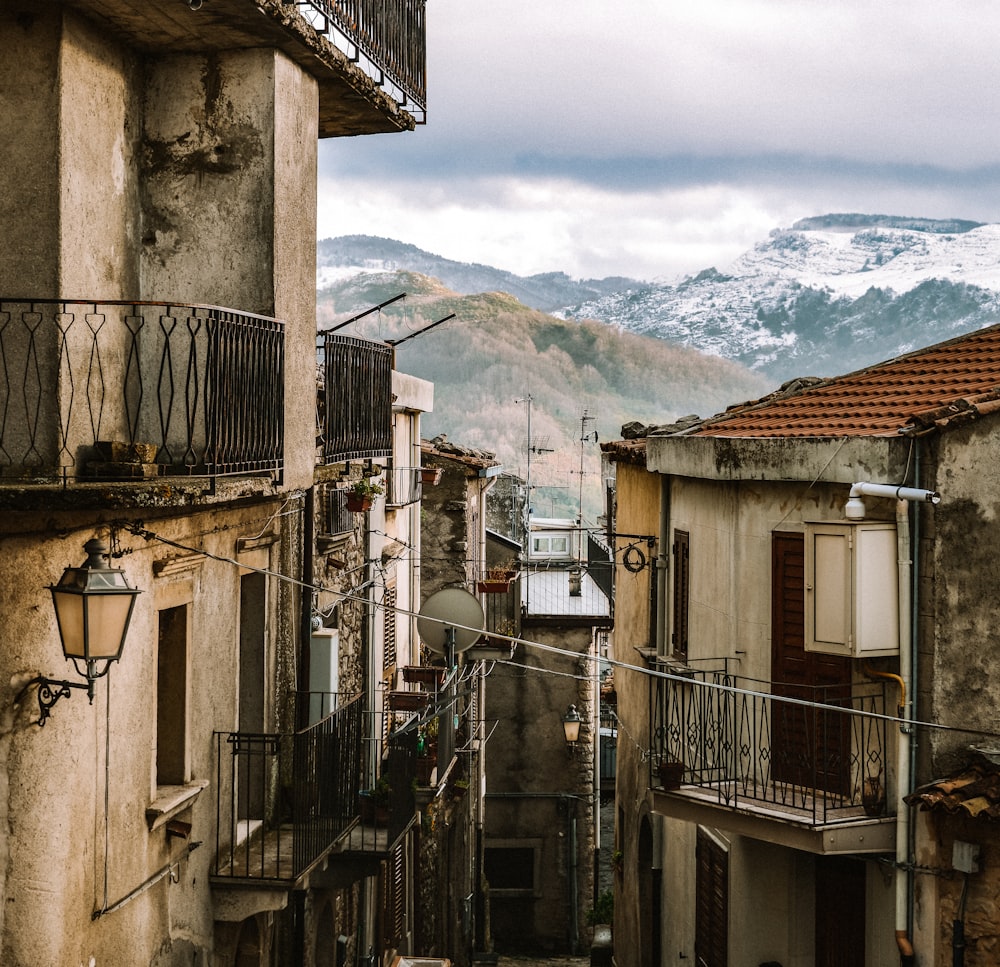 a view of a street with buildings and a mountain in the background