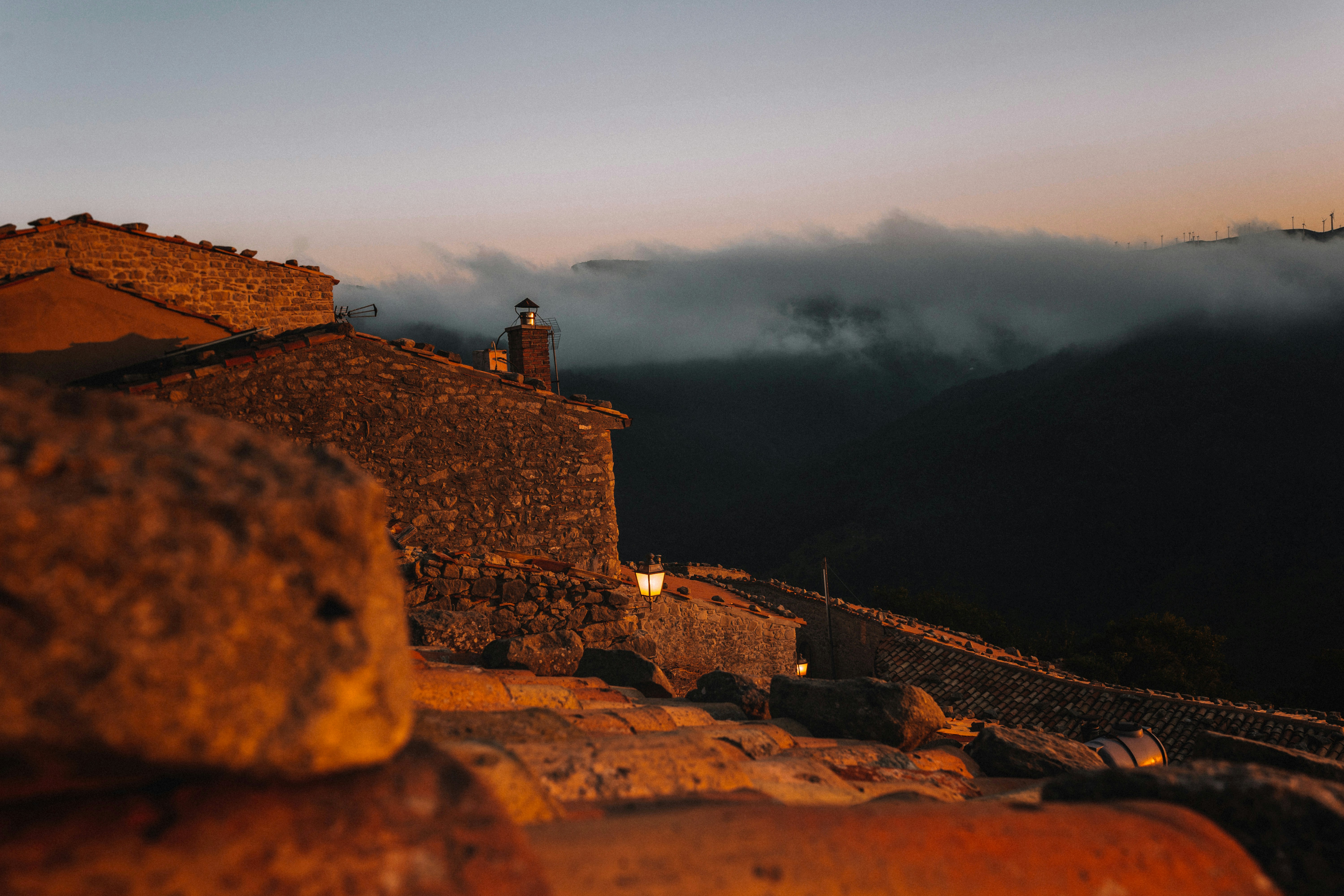 A stone building with a clock tower on top of it photo – Free ...