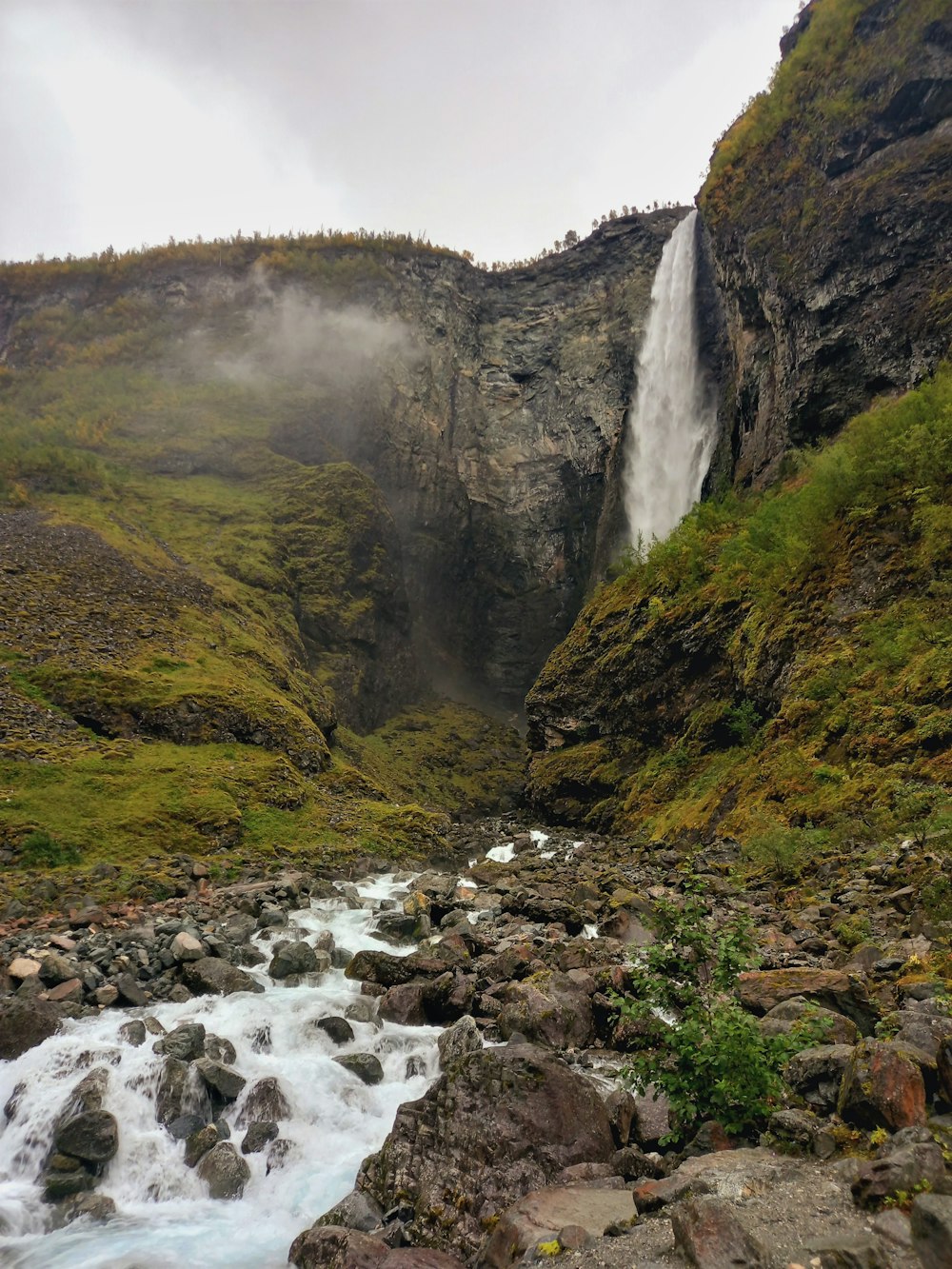 a waterfall with a small waterfall coming out of the side of it