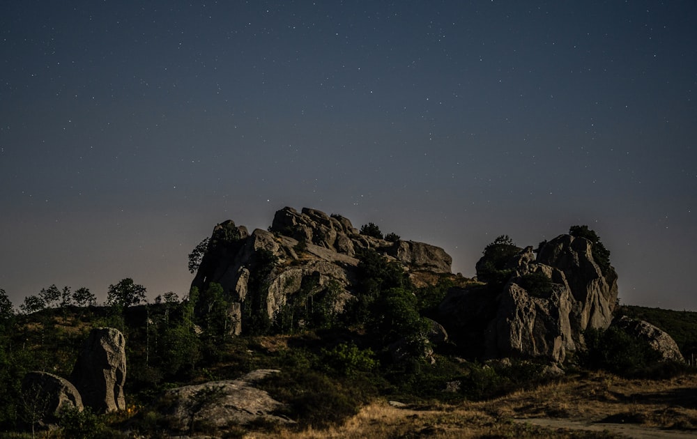 the night sky is full of stars and stars above some rocks