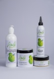 A set of four hair care products with white packaging, each featuring the word 'Amla' and an image of green fruit. The products include a herbal conditioning shampoo, herbal hair treatment, herbal hair oil, and herbal hair food.
