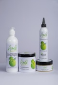 A set of four hair care products with white packaging, each featuring the word 'Amla' and an image of green fruit. The products include a herbal conditioning shampoo, herbal hair treatment, herbal hair oil, and herbal hair food.