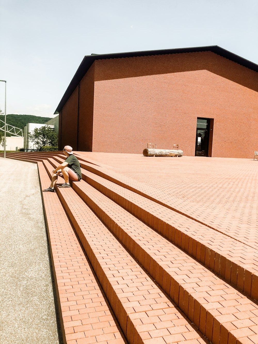 a man sitting on the steps of a building