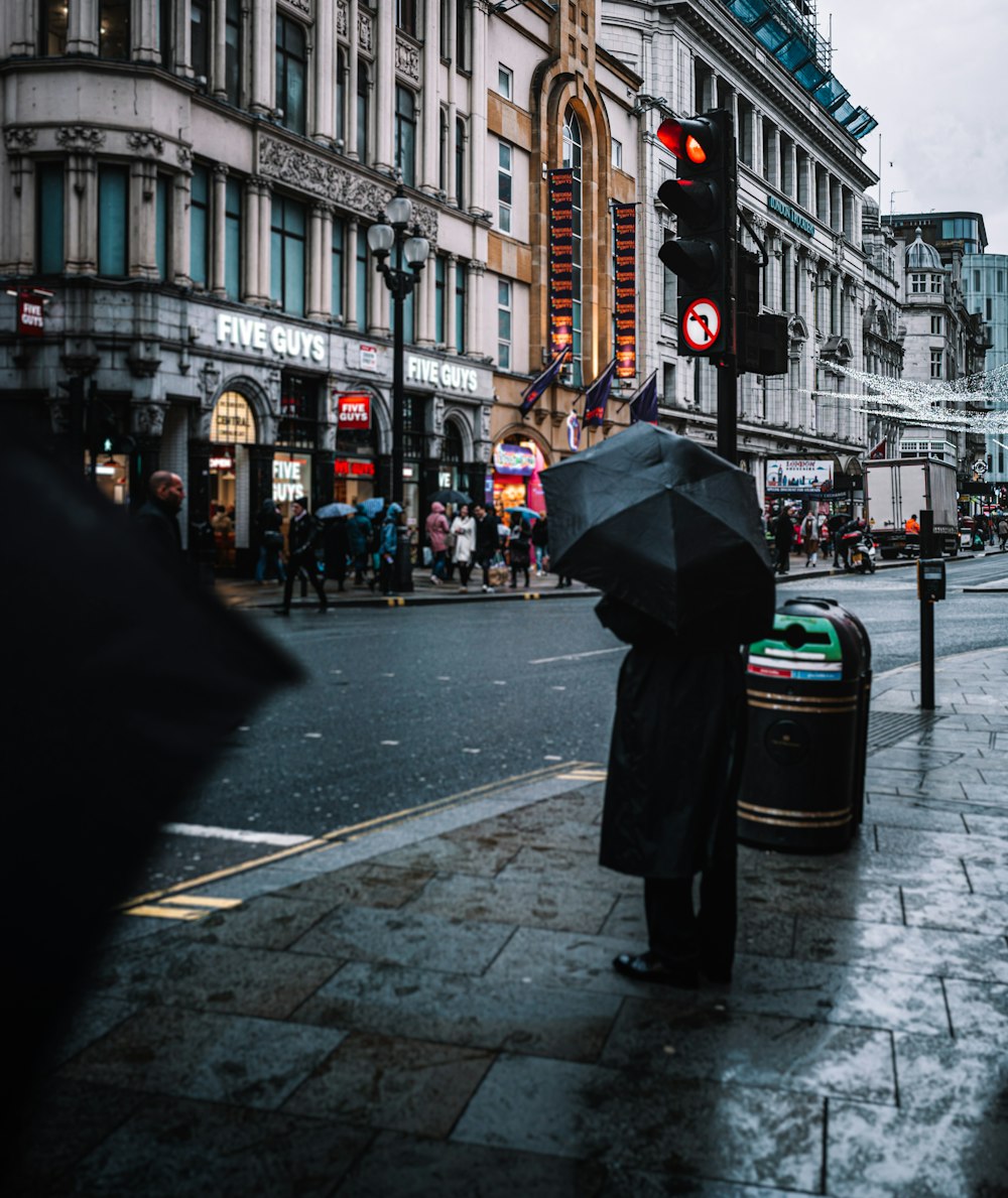 a person holding an umbrella on a city street