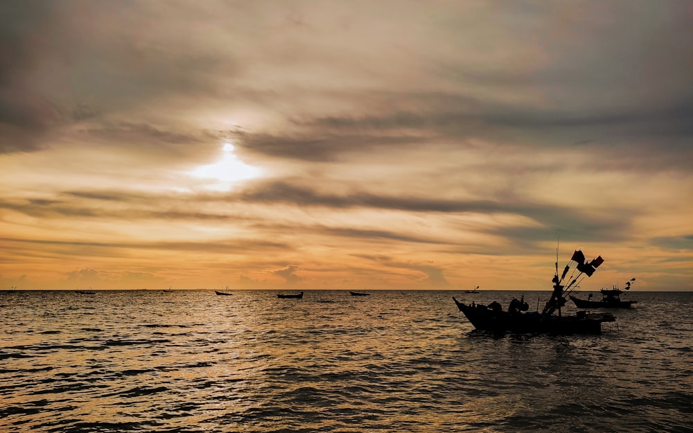 a couple of boats floating on top of a large body of water