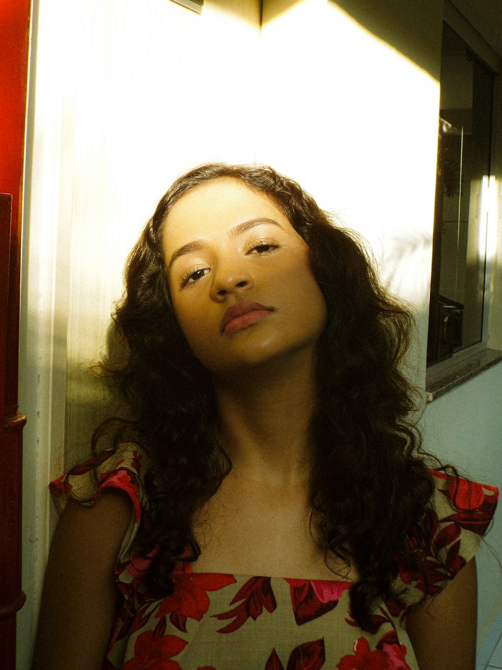 a woman with long hair standing in front of a mirror