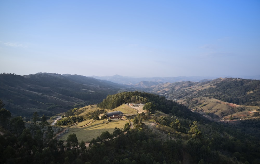 a scenic view of a mountain with a house on top of it