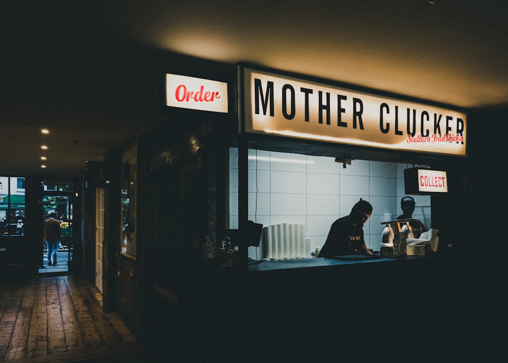 a woman sitting at a counter in front of a store