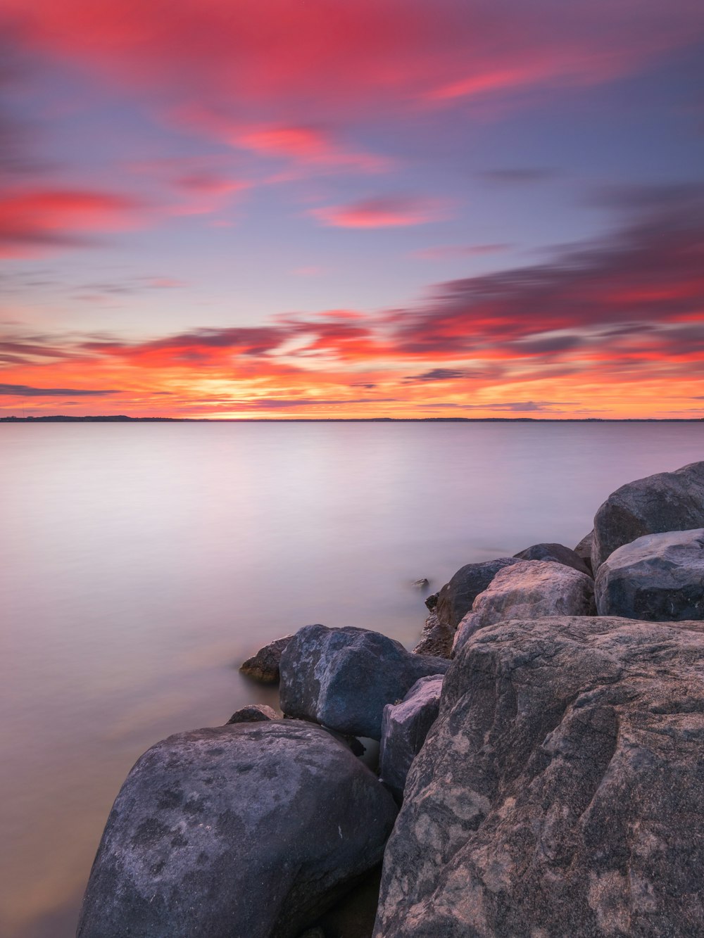 a long exposure photo of a sunset over the ocean