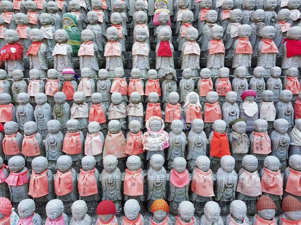 a large group of small statues of people