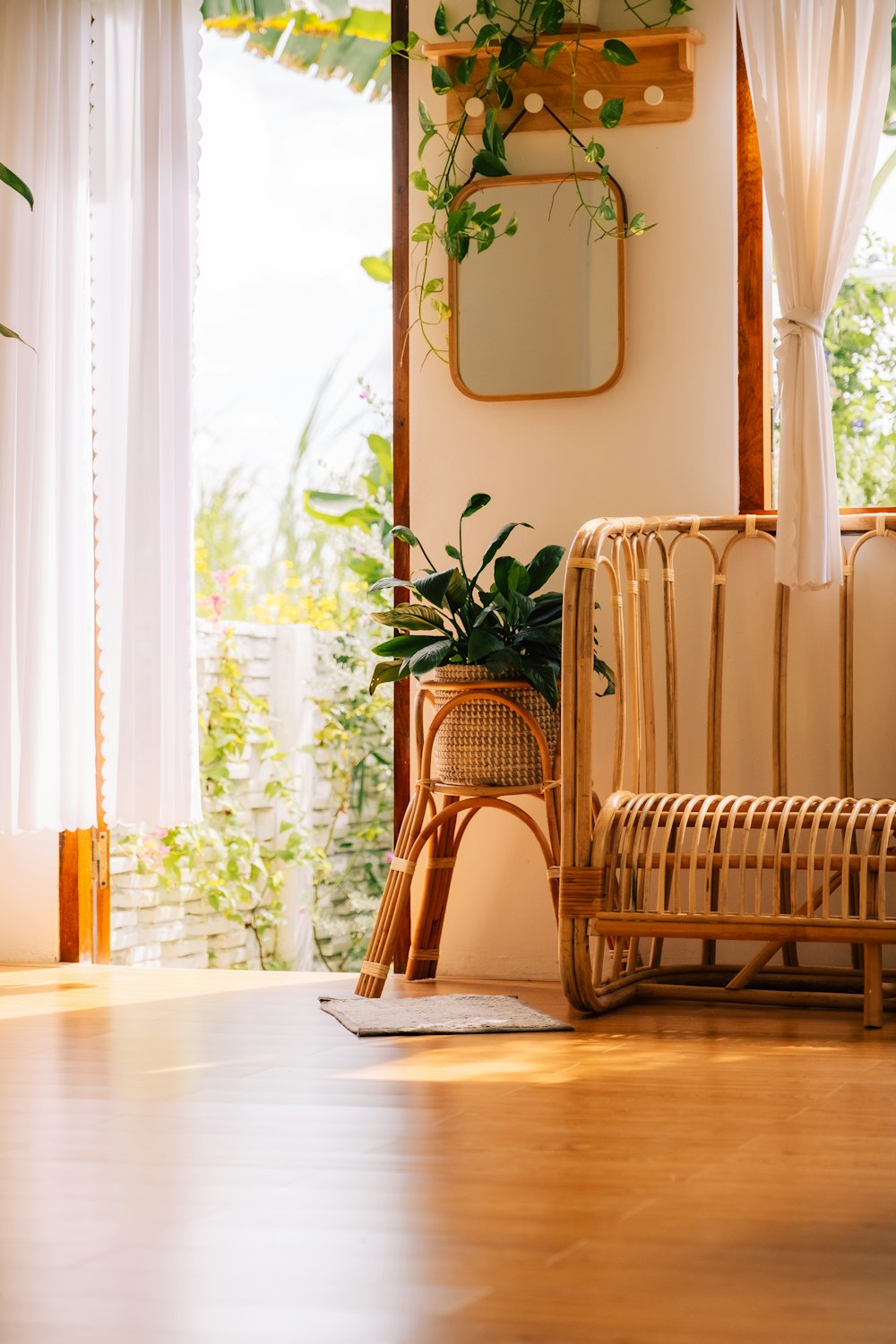 a living room with a wicker chair and potted plant