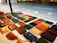 Close-up of handmade leather bracelets and wallets displayed on a wooden table.