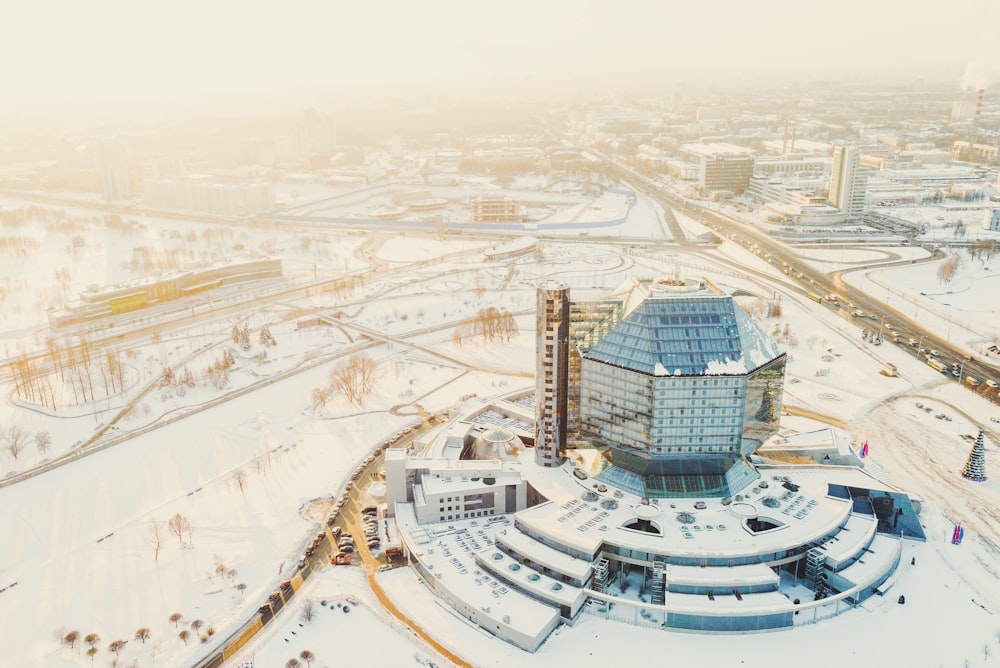 an aerial view of a building surrounded by snow
