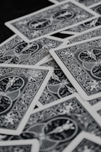 a pile of playing cards sitting on top of a table