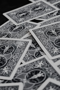 a pile of playing cards sitting on top of a table