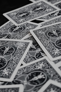 a pile of playing cards sitting on top of a table