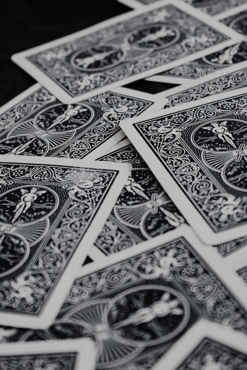 a pile of playing cards sitting on top of a table