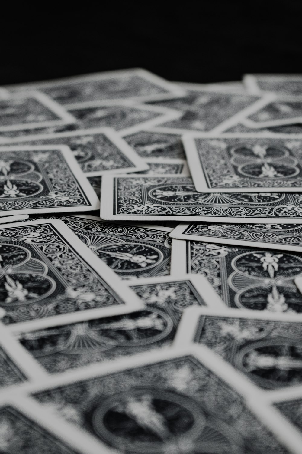 a pile of playing cards sitting on top of a table