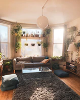 Bright living room with colorful boho cushions and natural light streaming through large windows.