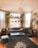 A clean, bright living room with freshly cleaned carpets and natural light streaming in.
