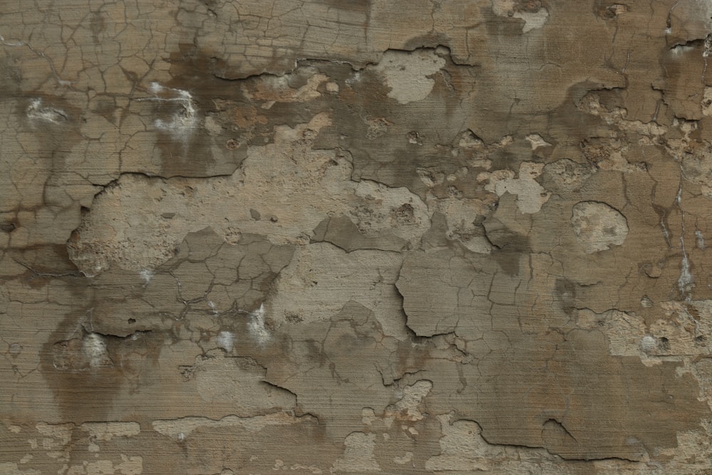 a close up of a wall with peeling paint