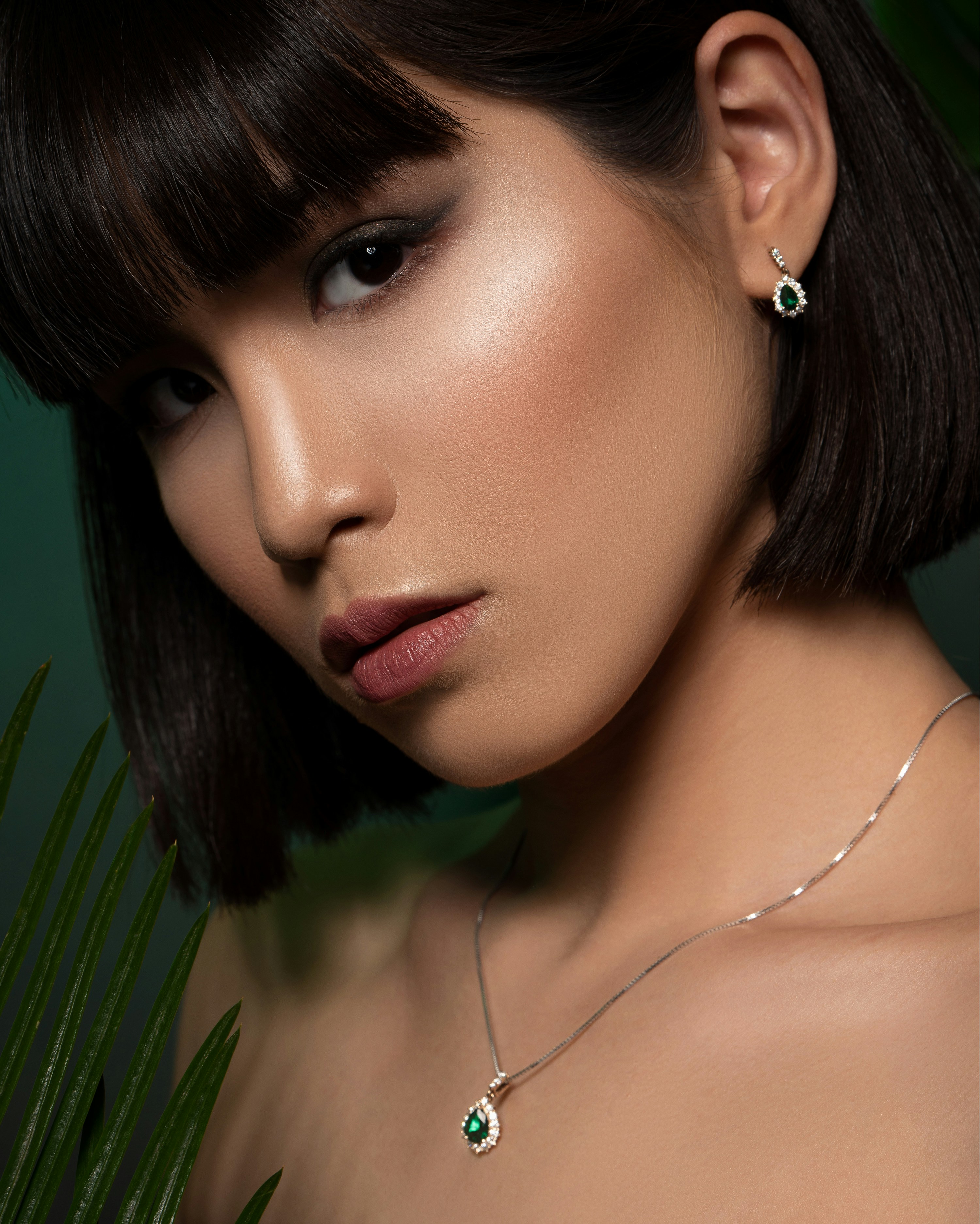 a woman with a necklace and earrings on her neck