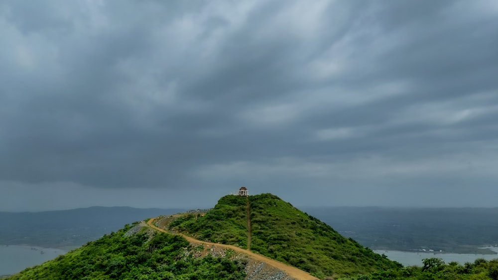 a person standing on top of a green hill