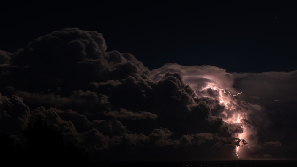 a large cloud with a lightning bolt coming out of it