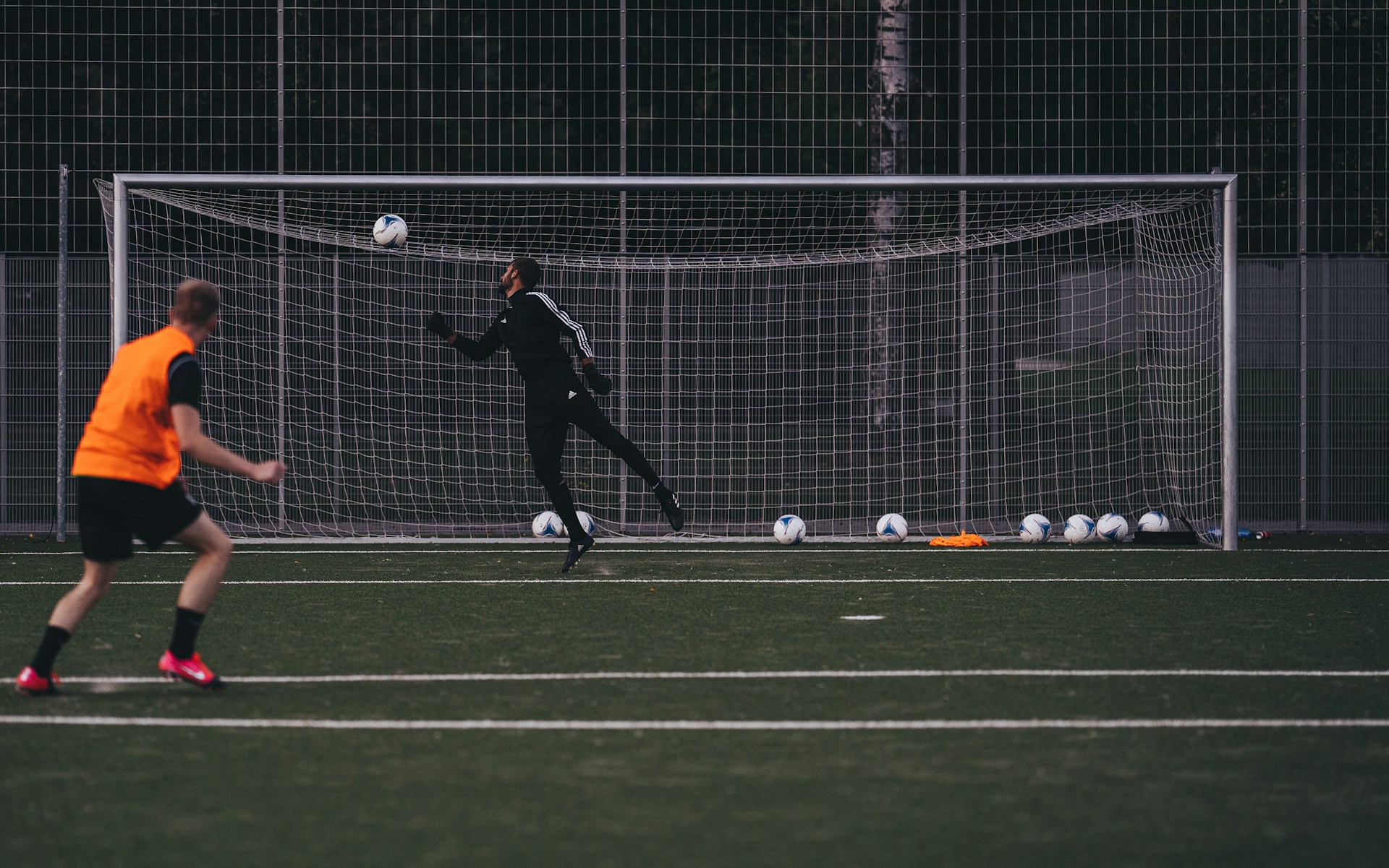 a couple of people on a field with a soccer ball