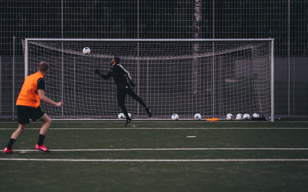 a couple of people on a field with a soccer ball