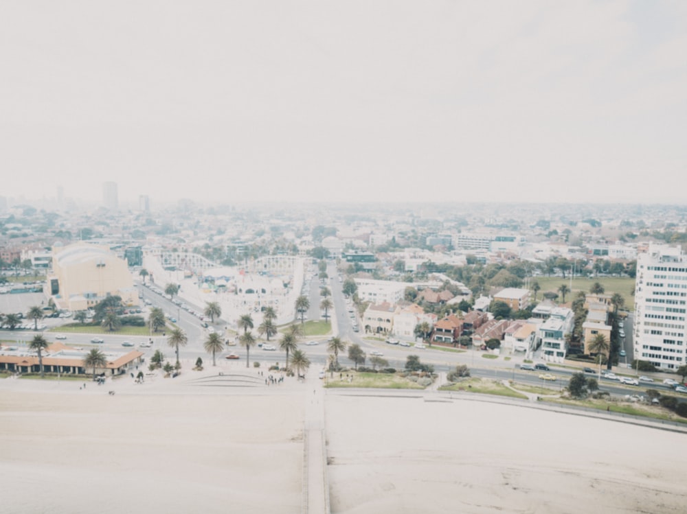 an aerial view of a city with palm trees