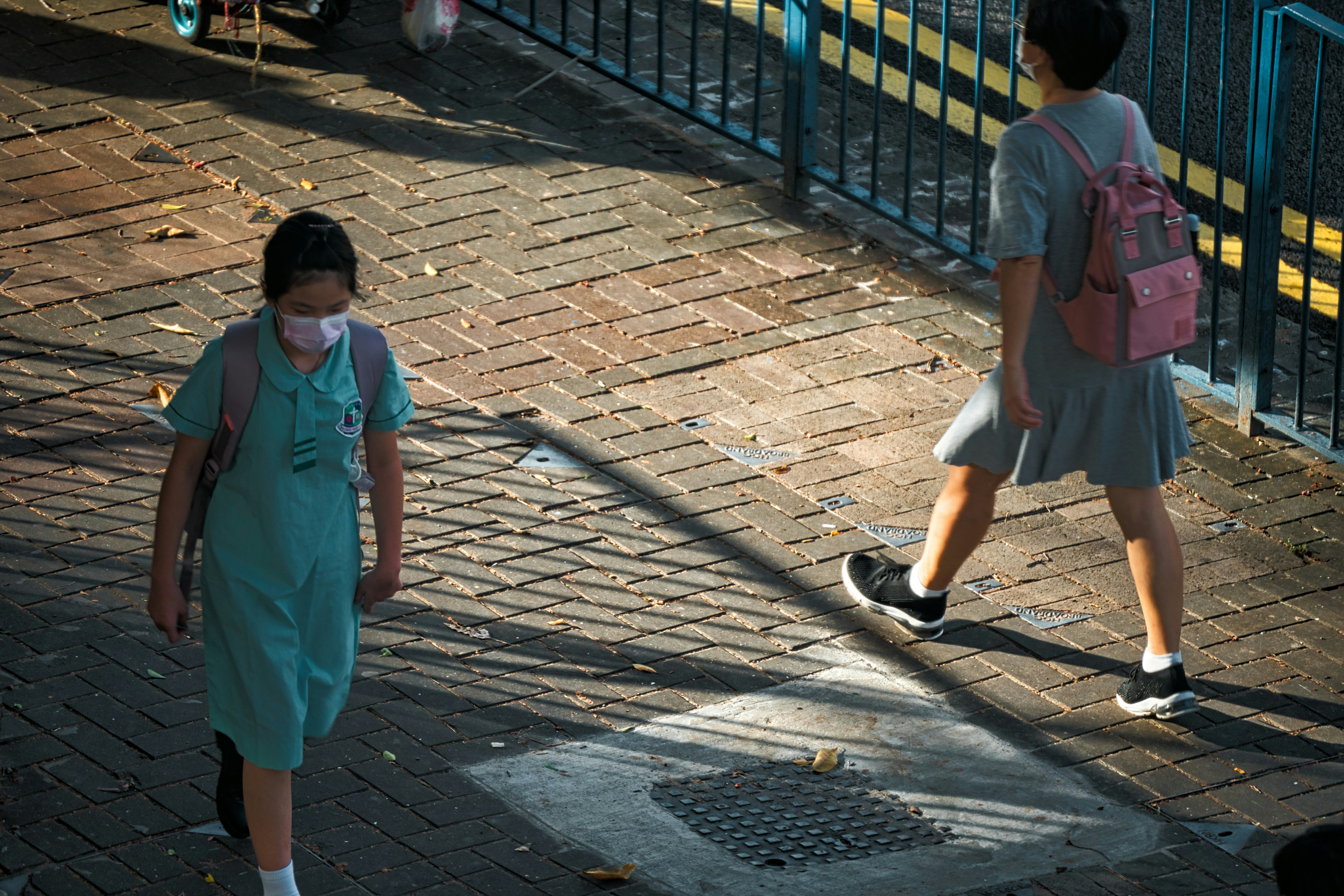 a couple of people that are walking down a street