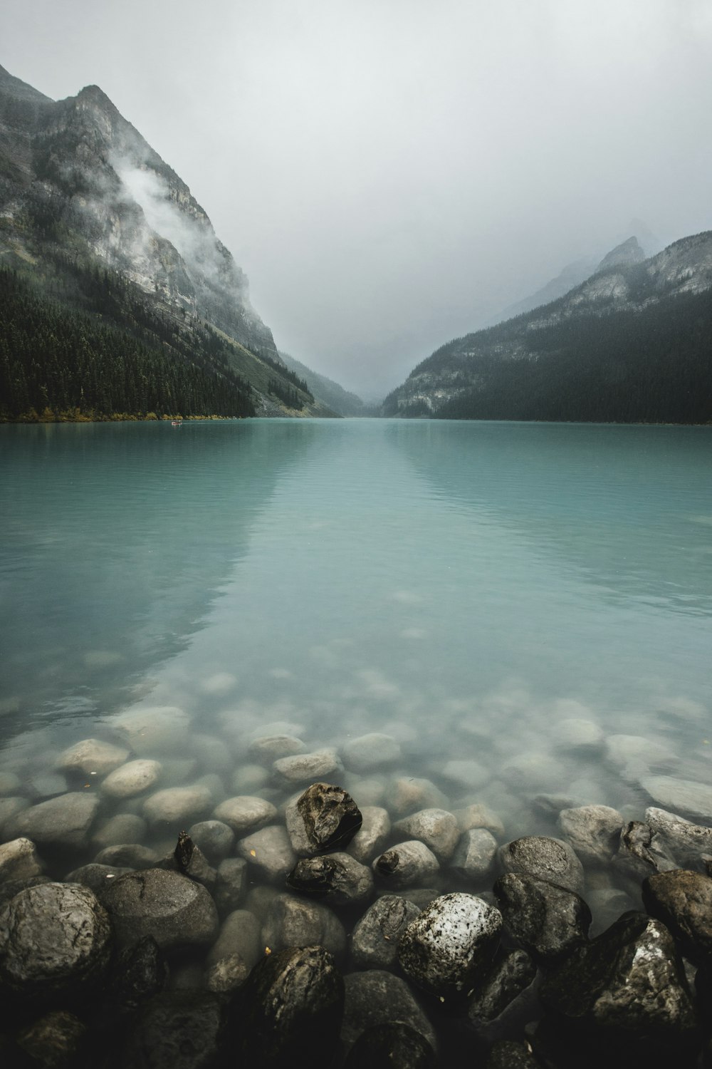 a body of water with a mountain in the background