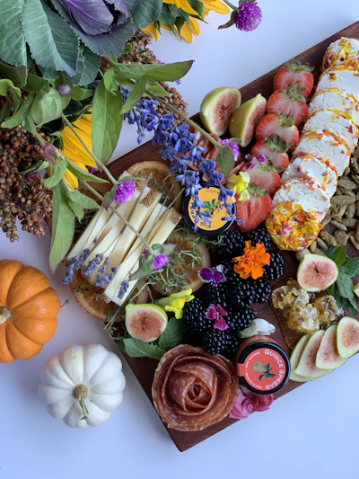 a platter of fruit and flowers on a table