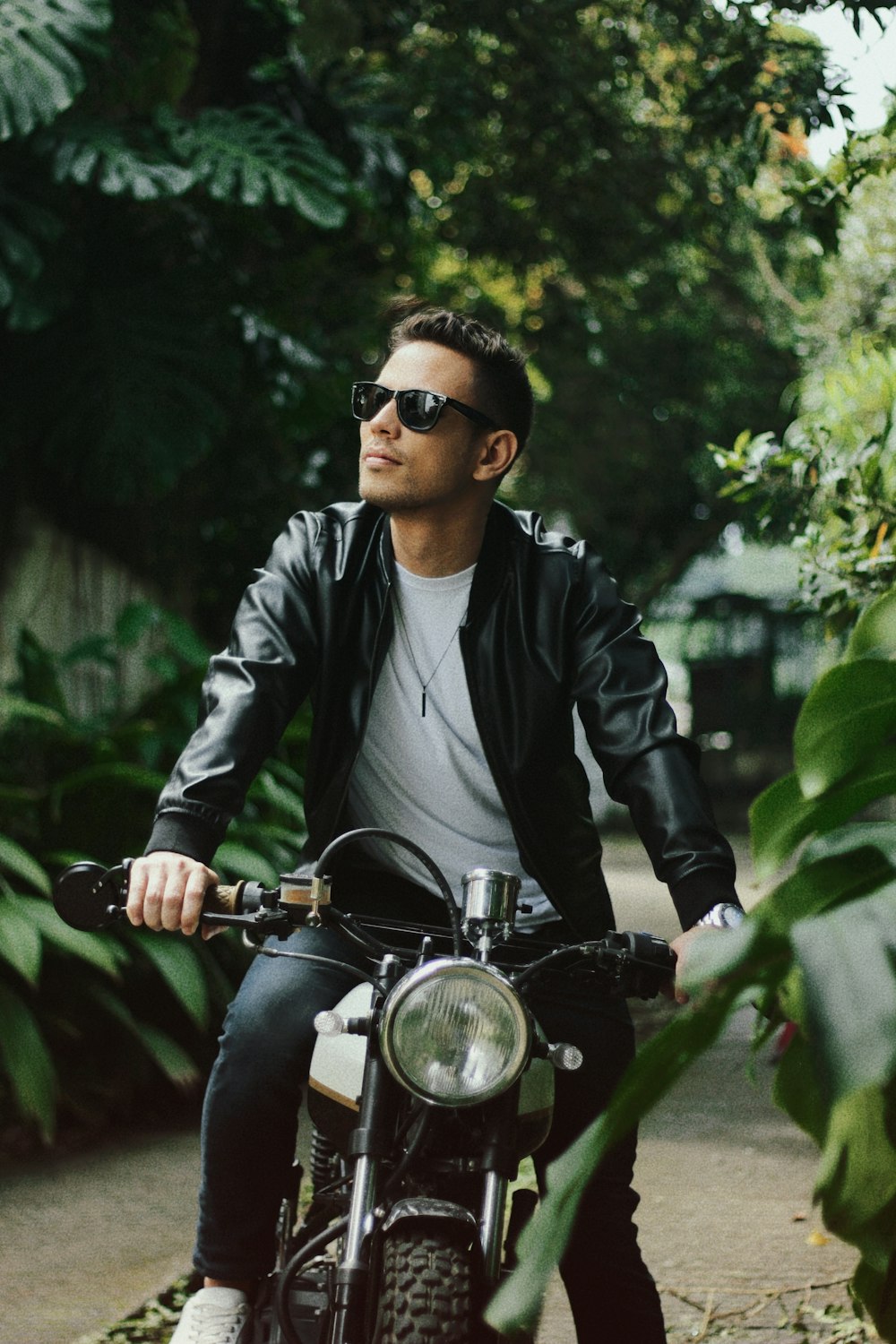 a man riding a motorcycle down a street