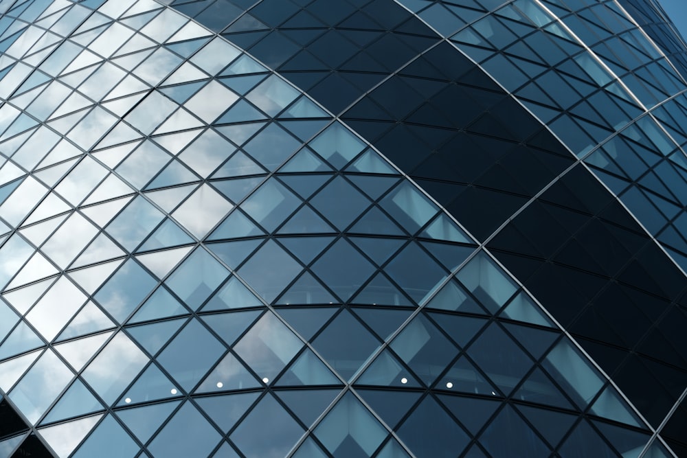 a tall glass building with a sky background