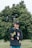 a person standing in front of a tree