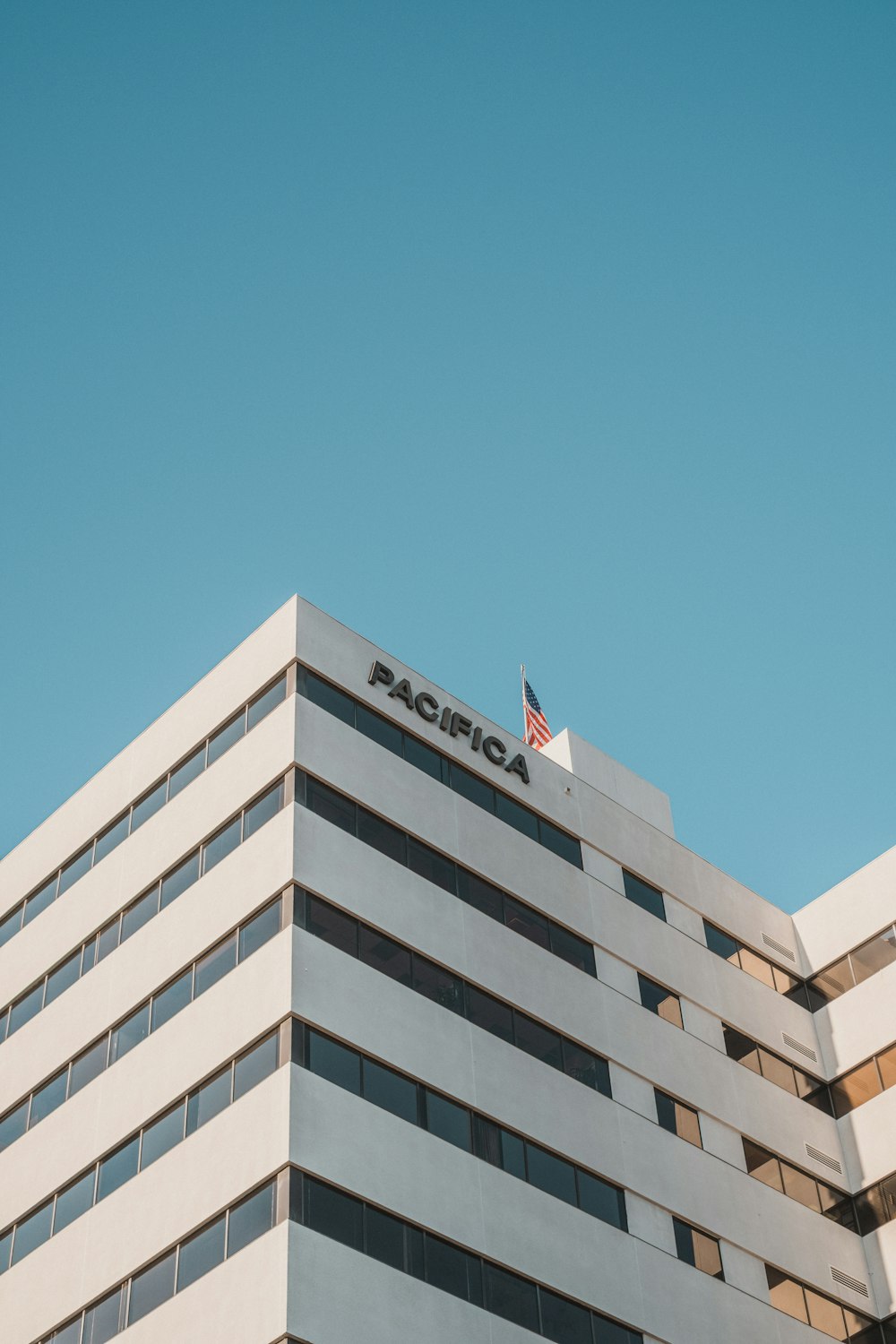 a tall building with a flag on top of it