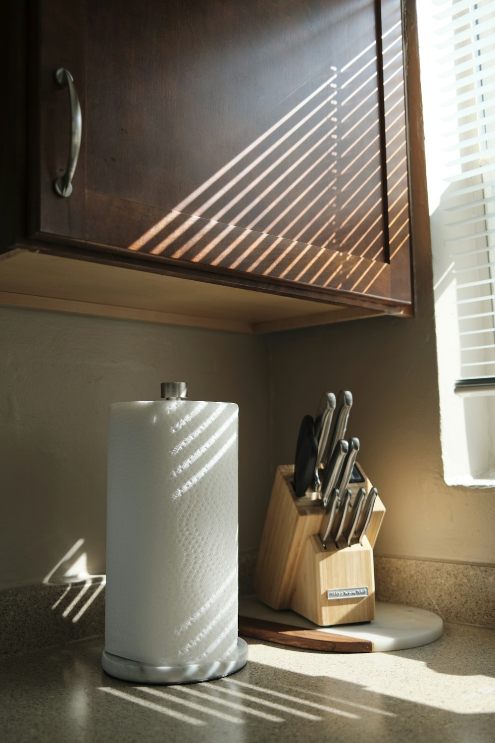 a kitchen counter with a cutting board and knife holder